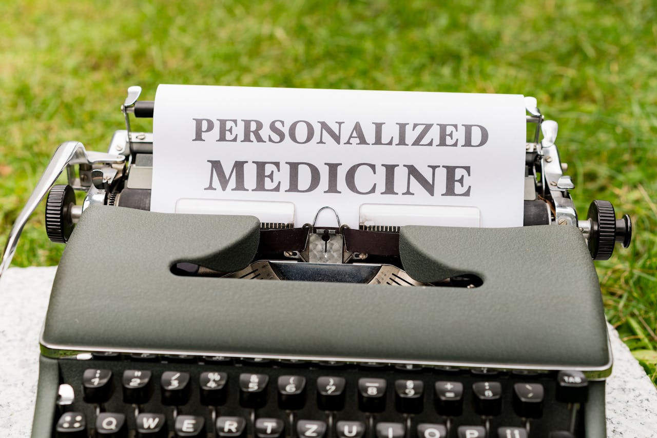 A vintage typewriter outdoors displaying a paper with the text Personalized Medicine.